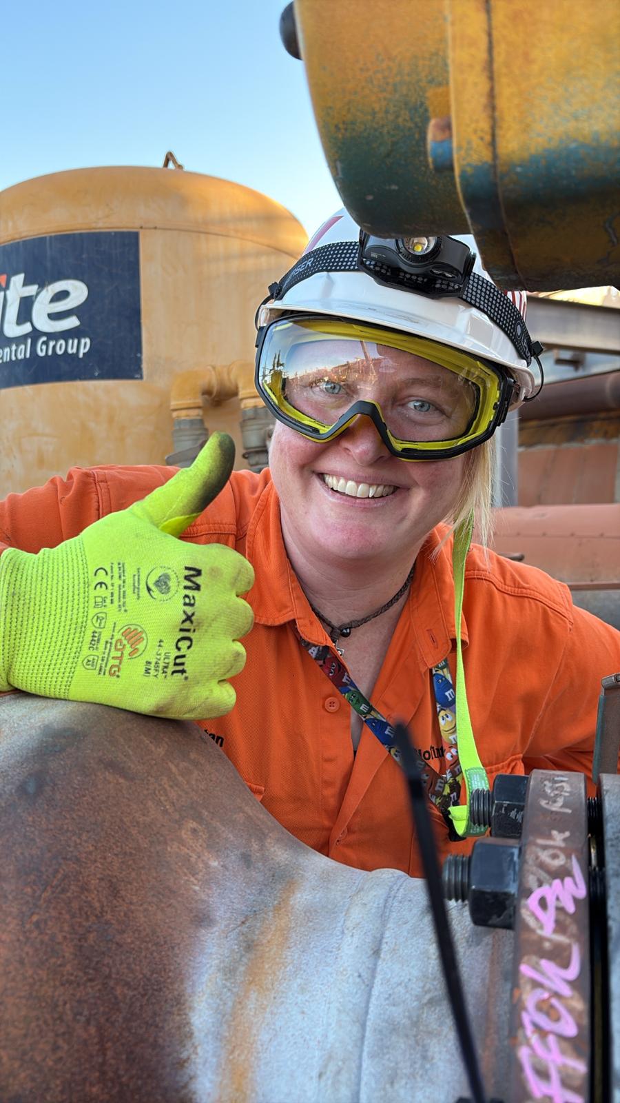 Katie Dunstan on site in high-visibility workwear, safety helmet and protective eyewear